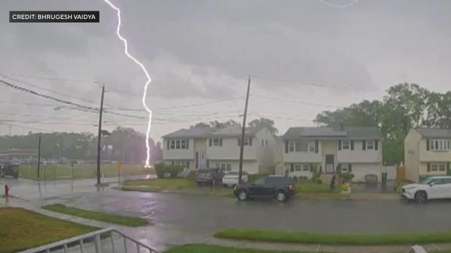 A bolt of lightning strikes Eric Baumgartner in Woodbridge Township, New Jersey, June 14, 2023, in a screen capture from security camera video footage. 