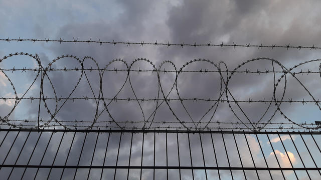 Low angle view of barbed wire against sky 