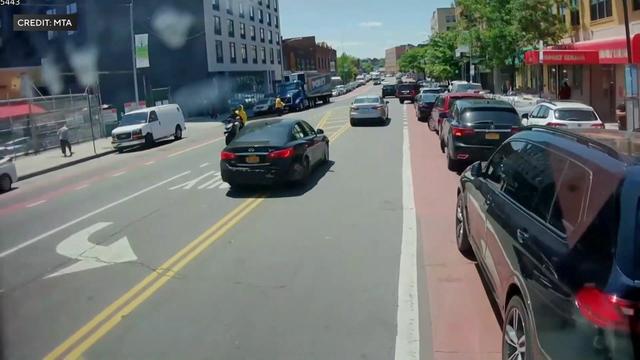 Video from a camera mounted on a bus shows vehicles parked in the bus lane. 