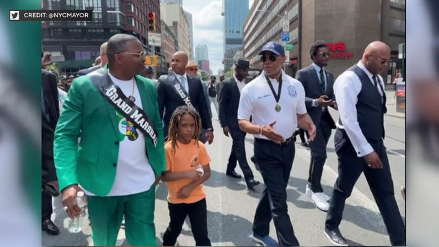 Mayor Eric Adams walks through the streets of Brooklyn with the grand marshal and other participants of the Annual Father's Day Walk and Talk. 