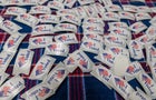 'I Voted" stickers cover a table at a polling place 