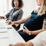 Pregnant Woman Working With Colleagues At Office 
