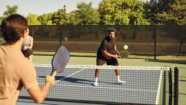 Young Adults Playing Pickleball on a Public Court 