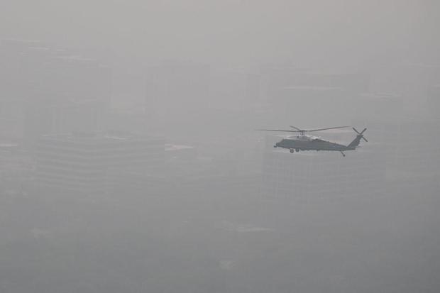 In this aerial view, Marine One carries President Biden over a hazy Chicago on June 28, 2023. 