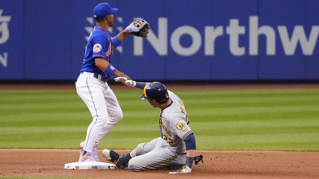 Milwaukee Brewers Left Fielder Christian Yelich (22) slides safely into second base with a double ahead of the throw to New York Mets Shortstop Francisco Lindor (12) during the first inning of a Major League Baseball game between the Milwaukee Brewers and 