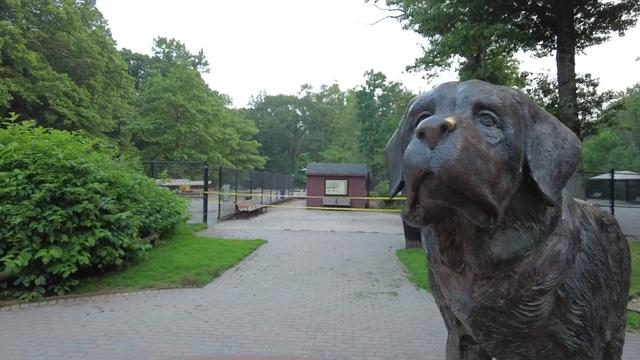 A statue of a dog outside the South Mountain Reservation dog park, which is blocked off with crime scene tape. 