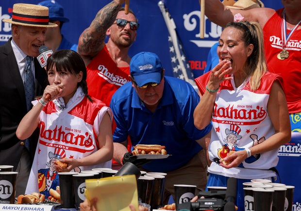 Mayoi Ebihara, left, and Miki Sudo compete in Nathan's Famous International Hot Dog Eating Contest on the Fourth of July at Coney Island in New York City, July 4, 2023.