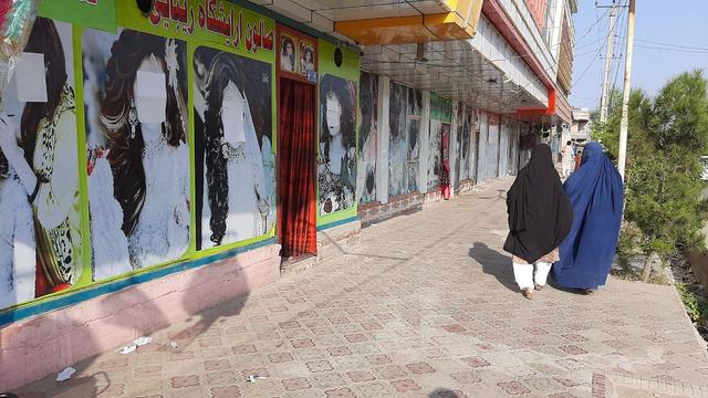 Women pictures outside beauty salons painted over in Afghanistan 