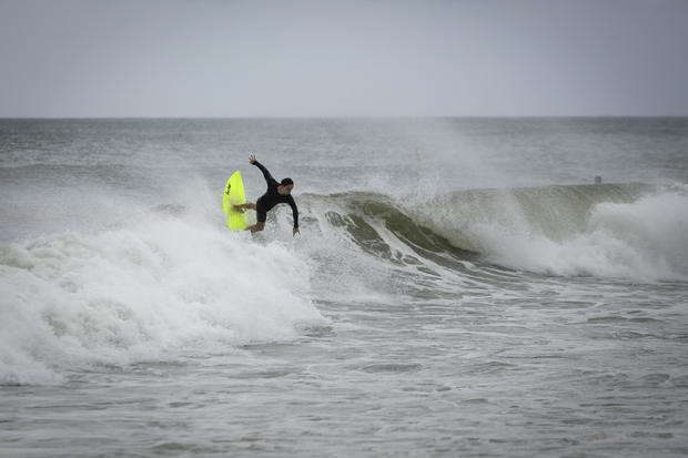 A surfer rides a wave in Deerfield Beach, Florida 