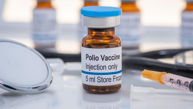 Polio vaccine vials with syringe and stethoscope 