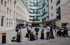 Members of the media gather outside Broadcasting House, the 