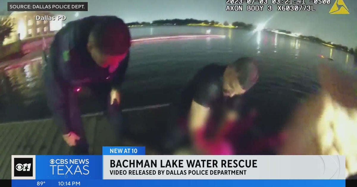 Dallas police officers save woman from car submerged in lake - CBS Texas