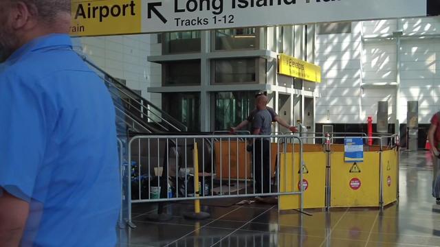 Gates block off the bottom of a broken escalator inside Jamaica Station. 
