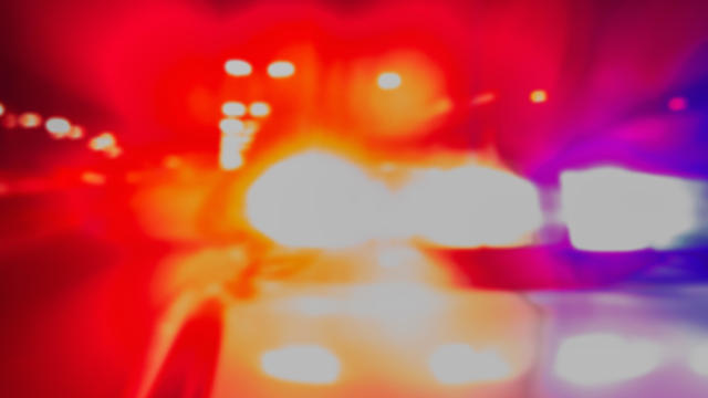 Police car lights in night time for crime news and accidents. Crime scene, night patrolling the city. Abstract blurry image. 