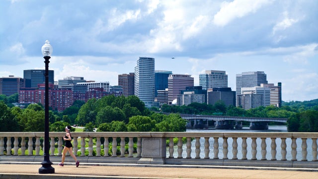 A runner crosses the Arlington Memorial Bridge over the Potomac River.