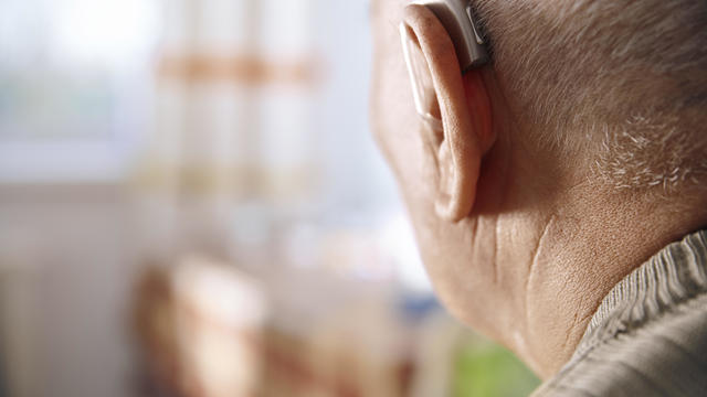 Ear of senior man with hearing aid 
