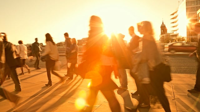 Business Commuters Walking Home After Work, Sunset Backlit, Blurred Motion 