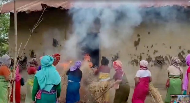 Women put burning hays in the house of the accused in viral Manipur video case, in Manipur