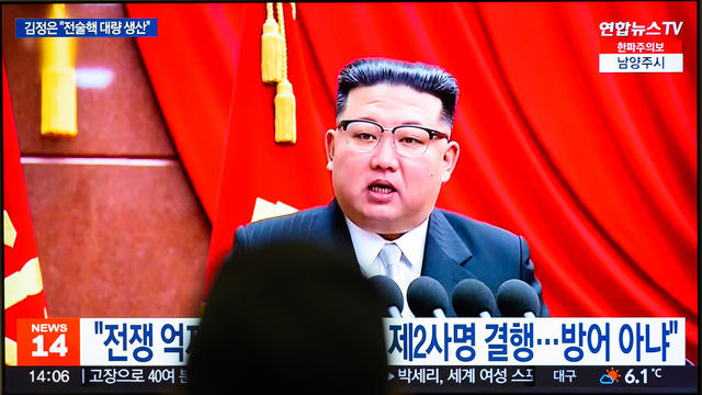 A TV screen shows footage of  North Korean leader Kim Jong- 