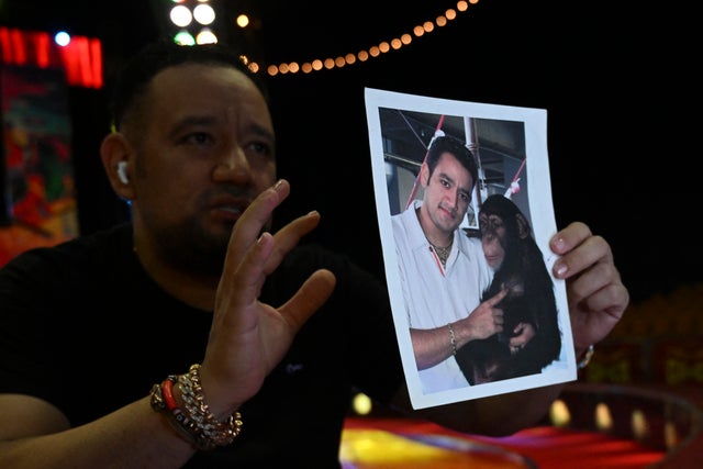 Circus owner Raul Gasca, ex-owner of Pancho, one of the chimpanzees killed after escaping from Ukumari Park in the city of Pereira, shows a picture in which he is holding the ape, at the Gasca Brothers Circus in Cali, Valle del Cauca Department, Colombia, on July 24, 2023. 