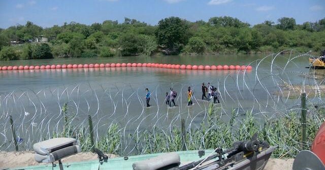 Justice Department sues Texas over floating border barriers in Rio ...