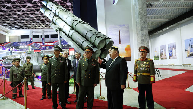 North Korean leader Kim Jong Un and Russia's Defense Minister Sergei Shoigu visit an exhibition of armed equipment 