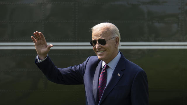 President Biden waves as he departs the White House 
