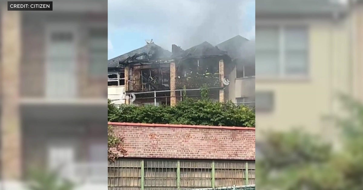 Firefighter, resident injured in Queens housing complex fire - CBS New York