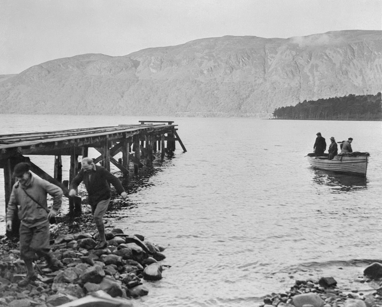 View of Residents in Small Boat and on Coast of Loch Ness 