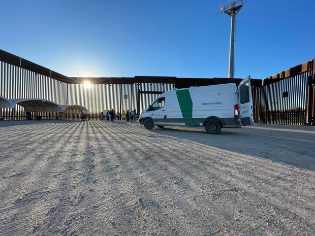 Migrant families and adults are processed by Border Patrol agents near San Luis, Arizona, after receiving water and food from local volunteers.