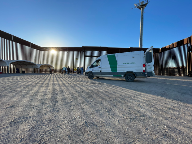 Migrant families and adults are processed by Border Patrol agents near San Luis, Arizona, after receiving water and food from local volunteers. 
