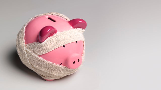 Ill piggy bank with bandages 