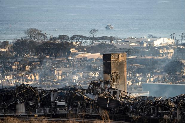 Smoke rises between the remains of buildings in Lahaina during the wildfire in Maui, Hawaii 