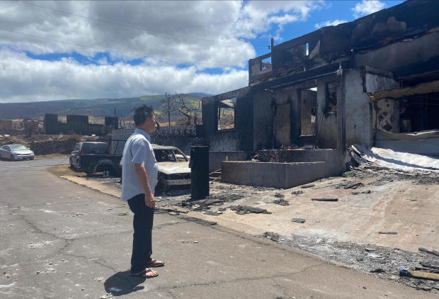 A man looks at burned out house in the aftermath of the wildfire in Lahaina, western Maui, Hawaii 