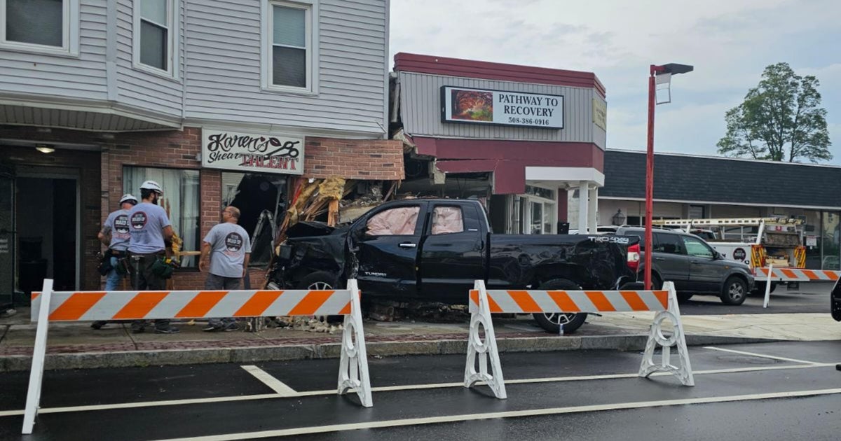 Pickup truck hits 3 parked cars, crashes into building on Broadway in