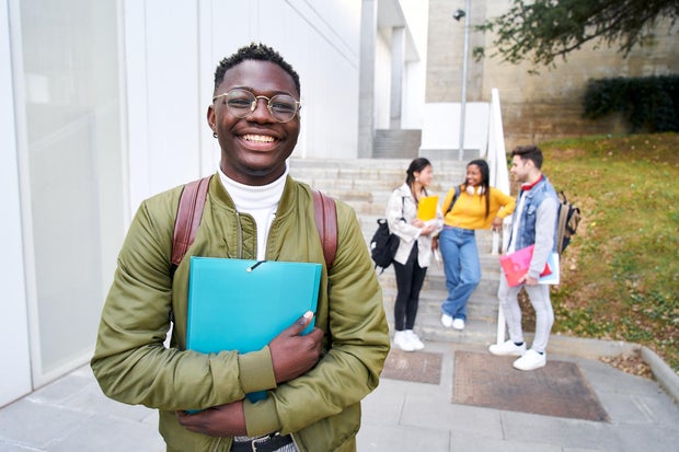 Happy African American young men looking at the camera out at the university campus.