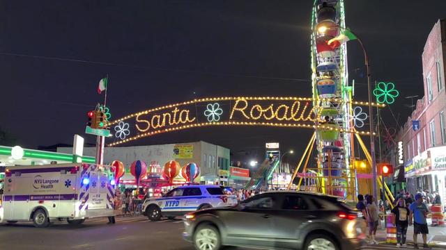A Ferris wheel can be seen behind a lighted sign reading "Santa Rosalia." 