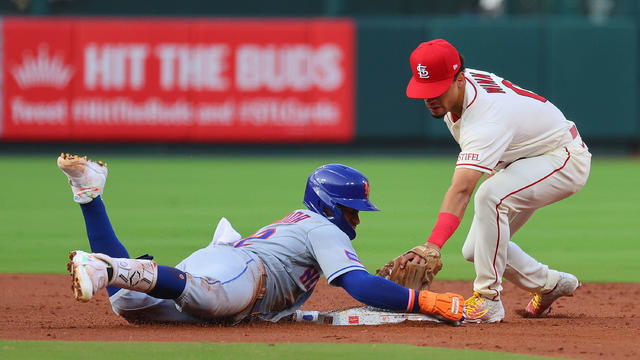 Francisco Lindor #12 of the New York Mets slides safely into second base against Masyn Winn #0 of the St. Louis Cardinals in the third inning at Busch Stadium on August 19, 2023 in St Louis, Missouri. 