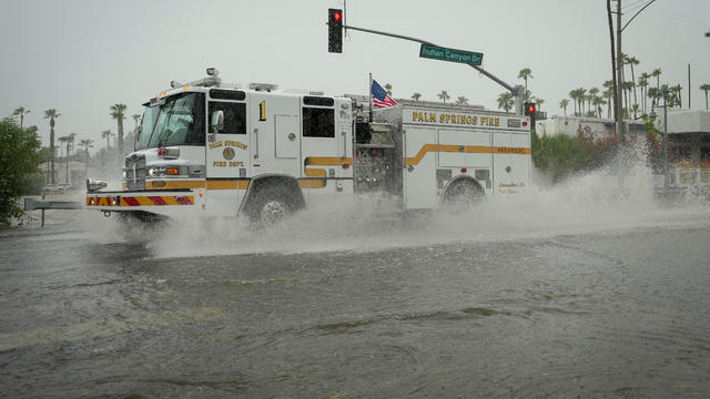 A view shows flood water moving across the road during Tropical Storm Hilary, in Palm Springs 