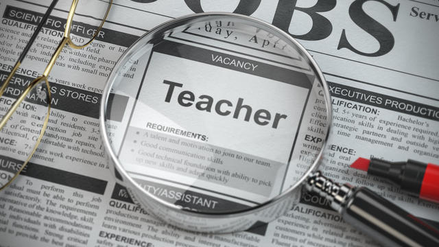 Teacher vacancy in the ad of job search newspaper with loupe. 