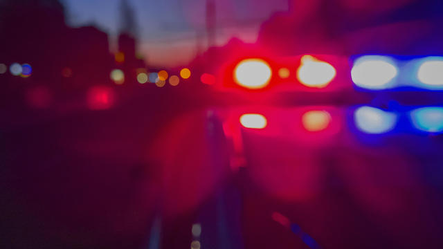 Red and blue Lights of police car in night time. Night patrolling the city. Abstract blurry image. 