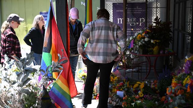 People gather near a makeshift memorial outside the Mag.Pi clothing store in Cedar Glen, near Lake Arrowhead, California, on August 21, 2023. 