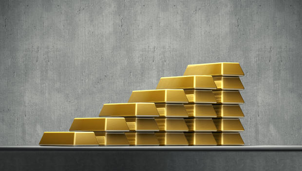 A growing stack of gold bars 