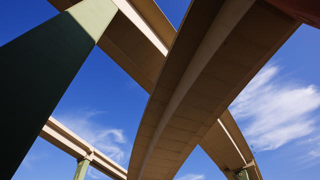 Low angle view of highway overpasses under blue sky 