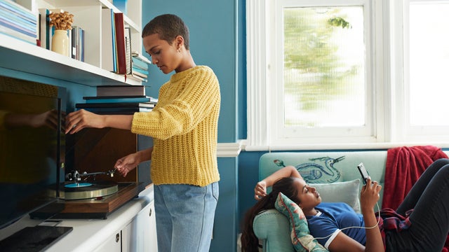 Friends spending leisure time while listening music 