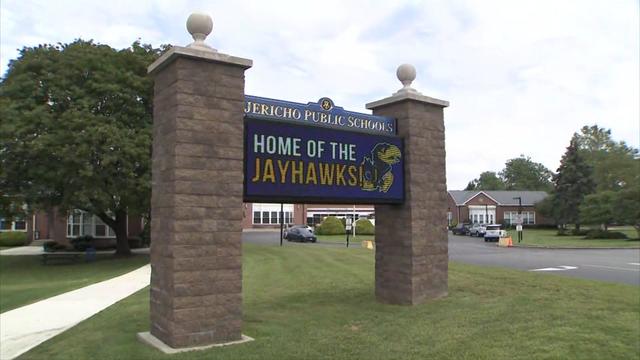 A sign for Jericho Public Schools with a digital graphic reading "home of the Jayhawks." 