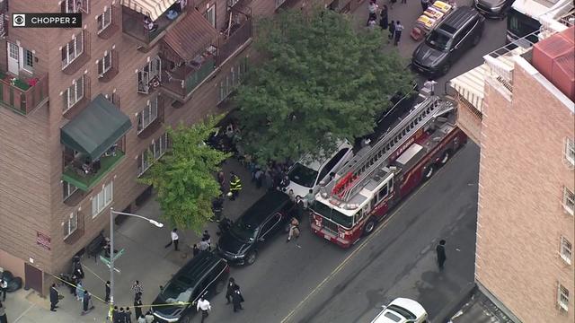 An aerial view of first responders outside a residential building in Williamsburg. 