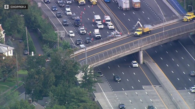An aerial view of traffic along I-87. Emergency crews have three lanes blocked off as they make repairs to an overpass. 