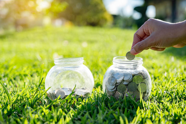 hand Put money Bottle Banknotes tree Image of bank note with plant growing on top for business green natural background money saving and investment financial concept 