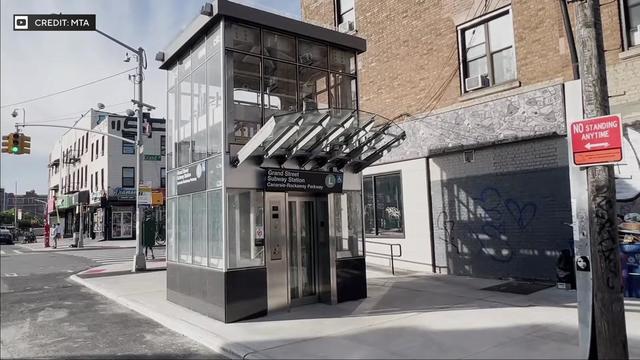 An elevator for the Grand Street subway station on the sidewalk. 